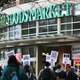 People rally rally outside a Whole Foods Market after marking from Amazon headquarters in solidarity with Amazon workers in Bessemer, Alabama, who hope to unionize, in Seattle, Washington on March 26, 2021.